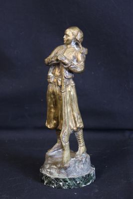 bronze statue of a man holding a bag on a black background