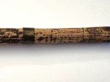 a knife with a wooden handle on a white surface