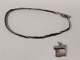 silver plated necklace with a small pendant on a black cord