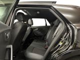 a black car with its door open and the back seats down