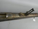 an old gun that is on display on the wall
