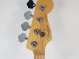 a close up of the headstock of a bass guitar
