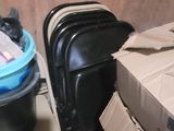 a pile of luggage sitting on the floor next to a trash can