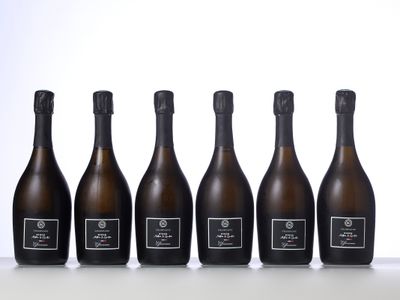 six bottles of champagne lined up in a row on a table