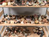 many different kinds of rocks and stones on the shelves