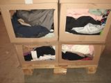 two boxes that have clothes in them on top of a pallet