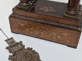 a clock that is sitting on a table next to a medal