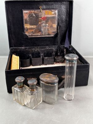 a black case with glass bottles and a brush in it