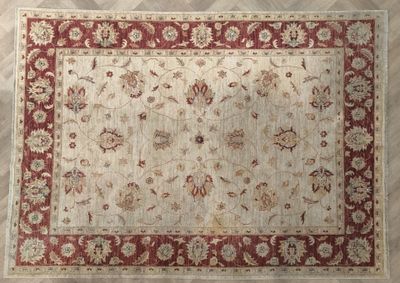 an image of a rug with a red border on a wooden floor