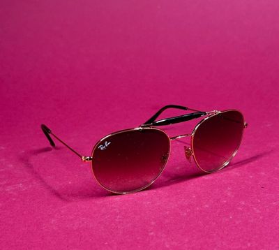 a pair of sunglasses on a pink background
