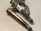 two lighters sitting on a table with a chain around them