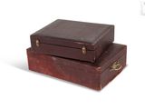 two brown suitcases stacked on top of each other