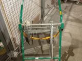a green and yellow cart in a garage