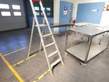 two ladders and a table in a large room