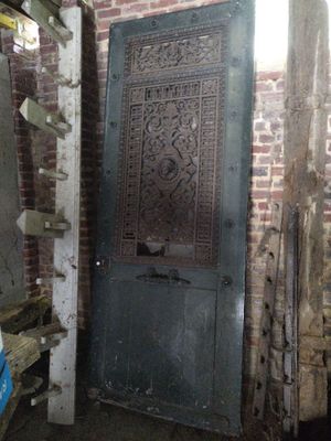 a door in a brick building that has a carved design on it