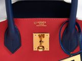 a red and blue handbag with a tag on it
