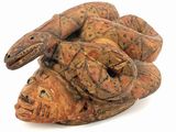 a wooden sculpture of a lizard on a white surface
