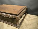 a wooden table with a wooden top on a parquet floor