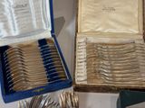 a box of silverware sitting on a table next to a box of silverware