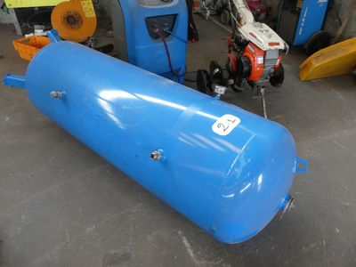 a blue tank sitting on the floor next to other equipment