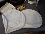 a white hat sitting on top of a table next to a box of matches