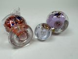three glass ornaments that are sitting on a table