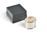 an image of a silver candle sitting next to a black box