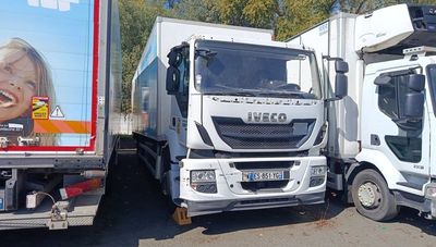 three trucks parked next to each other in a parking lot