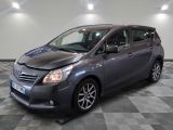 the grey toyota sienna is parked in a room with a checkered floor