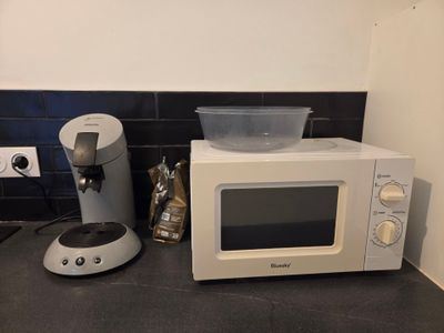 a microwave and a blender sitting on a kitchen counter