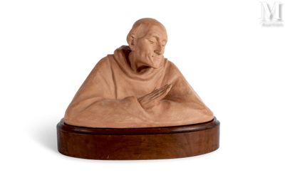 statue of a monk sitting on a wooden base on a white background