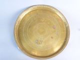 a gold plate with a circular design on it
