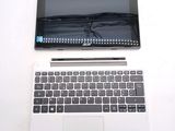 a laptop computer sitting on top of a white table