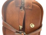 brown leather bag with zippers and handles on a white background