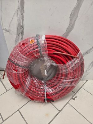 a red hose that is wrapped in plastic on the floor