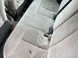 the interior of a car with dirty seats and dirty carpet