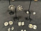 a group of silver and gold jewelry on display on a table