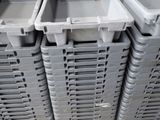 many plastic containers stacked on a pallet in a warehouse
