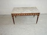 a small table with a marble top in a room