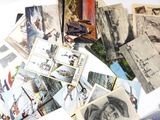 a pile of old postcards on a table