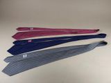 four ties are lined up in a row on a table