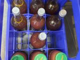 a blue plastic container filled with bottles of liquid