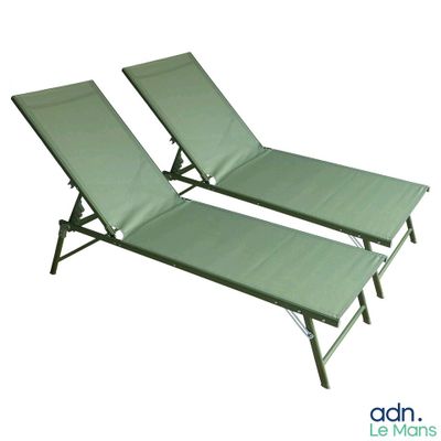 two green lounge chairs sitting next to each other on a white surface