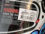 a close up of a helmet with a warning sticker on it