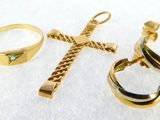 three rings and a cross on a white surface