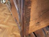 a wooden dresser with a glass top on a wooden floor