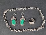 un gros plan d'un collier, d'un bracelet et d'une bague posés sur une table
