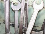 a lot of wrenches that are sitting on a shelf