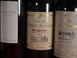 several bottles of wine are lined up on a shelf