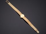 a gold watch on a black background